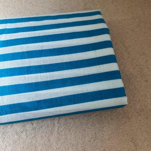 "Rolled Carnival Cotton fabric, highlighting its eco-friendly composition and smooth weave. Ideal for sewing elegant apparel, lightweight jackets, and decorative home textiles. The breathable fabric enhances airflow, ensuring a cool and comfortable feel."