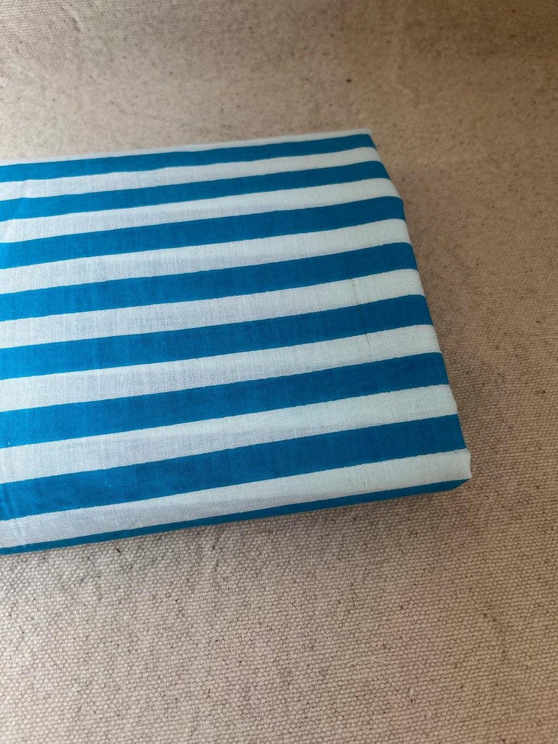 "Rolled Carnival Cotton fabric, highlighting its eco-friendly composition and smooth weave. Ideal for sewing elegant apparel, lightweight jackets, and decorative home textiles. The breathable fabric enhances airflow, ensuring a cool and comfortable feel."
