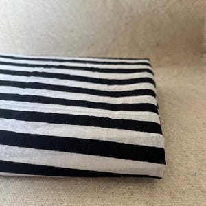 "Close-up of Carnival Cotton fabric, showcasing its vibrant colors and soft texture. Ideal for sewing dresses, blouses, quilting, and home décor. The breathable cotton ensures comfort, making it perfect for vintage-inspired and modern sewing projects."