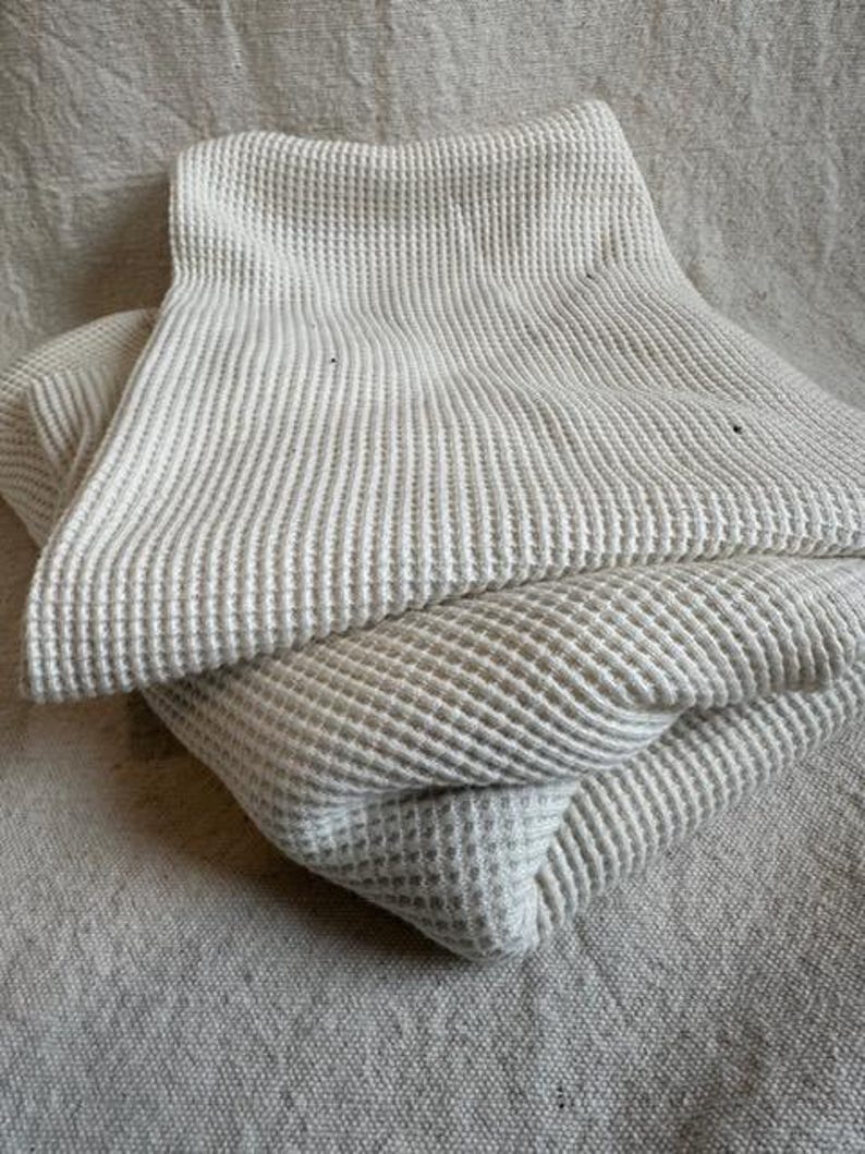 Close-up view of premium heavyweight cotton waffle knit fabric featuring a raised waffle texture. This durable cotton knit is perfect for thermal tops, sweatshirts, pullovers, robes, and blanket sewing projects. The fabric has a cozy feel with excellent structure while remaining breathable and comfortable against the skin. Ideal for makers looking for a high-quality waffle knit fabric sold by the half yard for garment and home sewing.