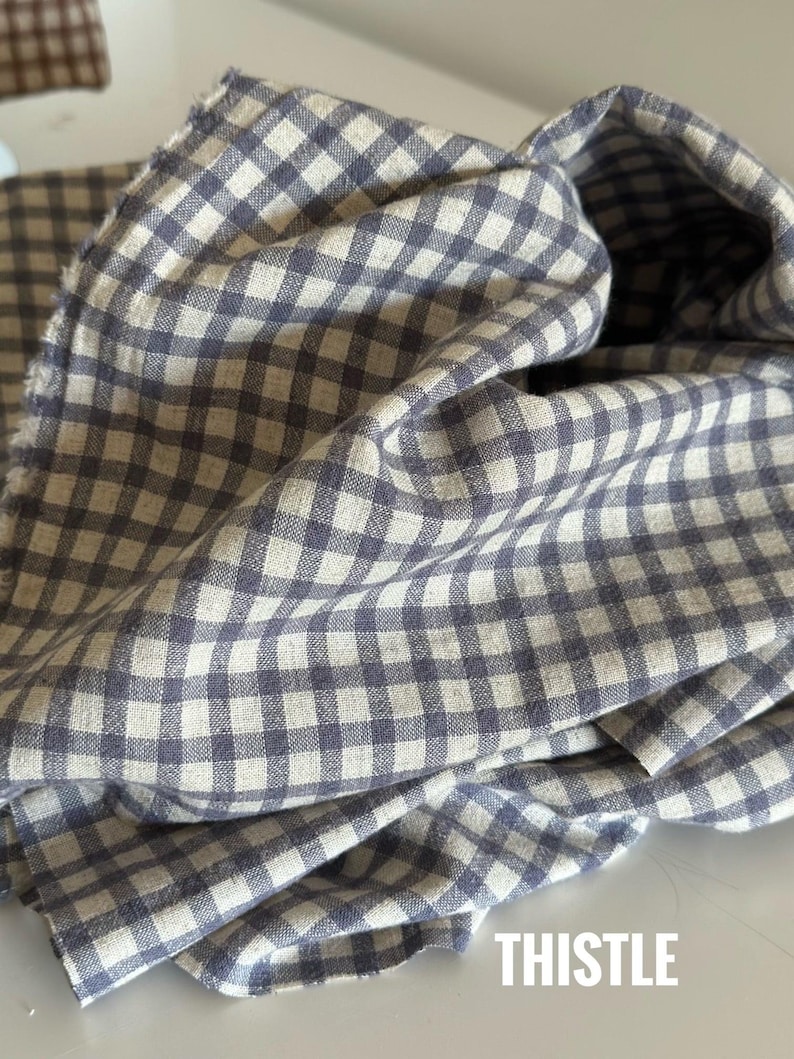 "Close-up of gingham linen-cotton blend fabric, highlighting its soft, breathable texture and timeless checkered design. Ideal for sewing apparel, home décor, and handmade crafts. The eco-friendly blend combines linen’s durability with cotton’s softness, making it perfect for lightweight garments and stylish accessories."