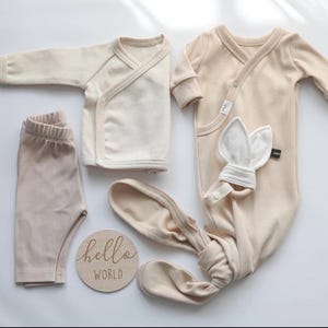 "Stacked organic cotton 2x1 rib knit fabric, showcasing its smooth, breathable texture and soft drape. Perfect for sewing t-shirts, dresses, and lounge sets. The natural cotton fibers provide a comfortable feel, making it a great choice for everyday wear and sustainable fashion."