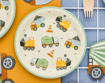 May include: A set of 8 white paper plates with a green border. The plates feature a repeating pattern of construction trucks and cones in yellow, orange, green, and blue.