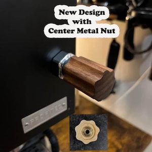 May include: Close-up of a wooden knob with a metal centre nut. The knob is attached to a black espresso machine. The text "New Design with Centre Metal Nut" is written in white on a white speech bubble.