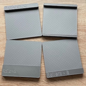 May include: Four gray rectangular printing rollers labeled "Rollers - A", "Rollers - B", "Rollers - C", and "Chuck".