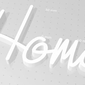 May include: White 3D word "Home" with a shadow. The word is 100 mm wide and 50 mm tall.