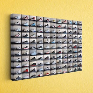 May include: A wall-mounted display case filled with rows of colorful sneakers. The shoes are arranged in individual compartments, showcasing a variety of styles and color combinations. The display is mounted on a yellow wall.