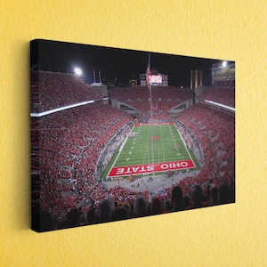 a picture of a football stadium at night