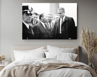 May include: A black and white rectangular wall art print featuring a historical photograph of Martin Luther King Jr. and Malcolm X standing together among a group of men in suits and ties, with a police officer visible on the far left side.