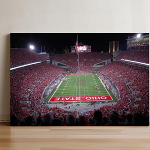 a football stadium filled with people watching a game