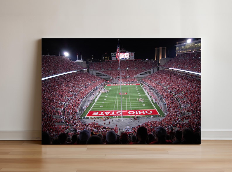 a football stadium filled with people watching a game