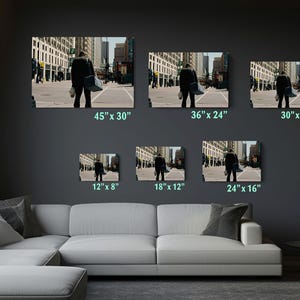 a living room filled with furniture and pictures on the wall
