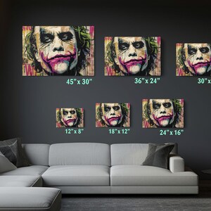 a living room with a couch and paintings on the wall
