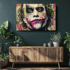 a painting of the joker on a green wall