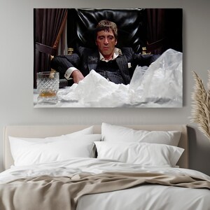 a bedroom with a large picture of a man sitting in a chair
