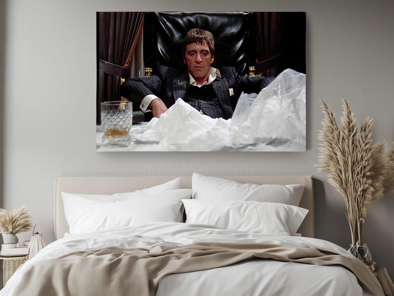 a bedroom with a large picture of a man sitting in a chair