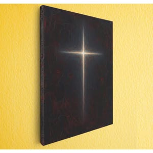 May include: A canvas art piece featuring a glowing cross against a dark, textured background. The cross is bright white and gold, with a soft, ethereal glow. The background is a deep, mottled black with hints of red.