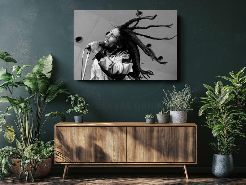 a black and white photo of a man with dreadlocks