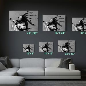 a living room with a white couch and four pictures on the wall