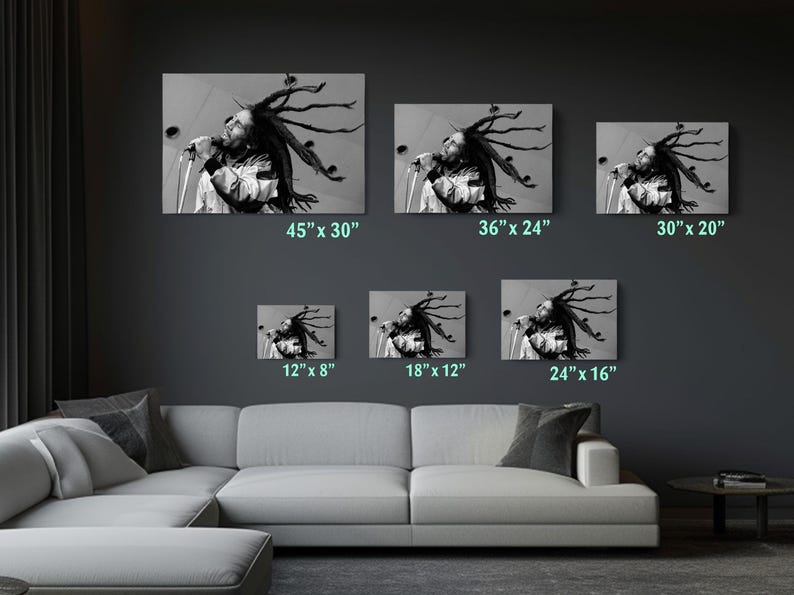 a living room with a white couch and four pictures on the wall
