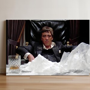 a man sitting in a chair with a glass in front of him