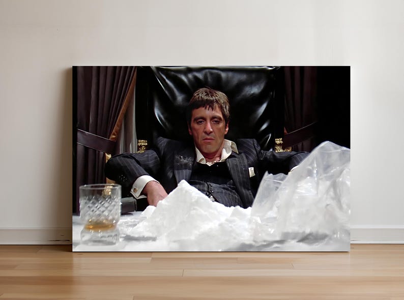 a man sitting in a chair with a glass in front of him