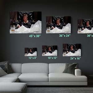 a living room filled with furniture and pictures on the wall