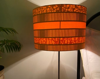 Double-sided lampshade - 30cm diameter with plain orange outer and orange striped Ankara inner fabric