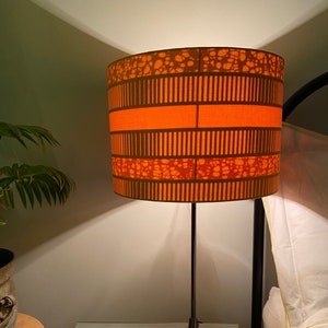 Double-sided lampshade - 30cm diameter with plain orange outer and orange striped Ankara inner fabric