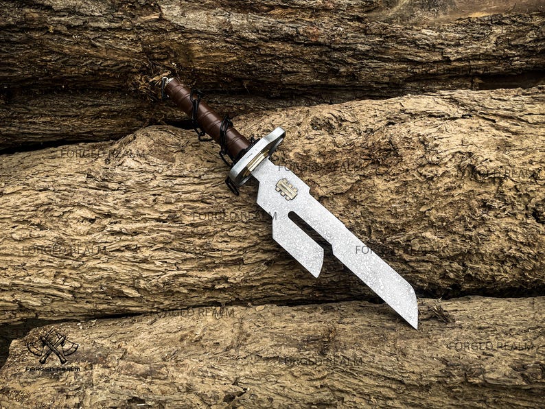May include: A metal dagger with a textured, silver-toned blade featuring a distinct cutout notch near the hilt. The handle is wrapped in dark brown leather with black cord lacing. A small rectangular metal plate is embedded on the blade surface.