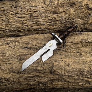 May include: A fixed-blade knife with a textured, patterned steel blade featuring a rectangular cutout near the spine. The handle is wrapped in dark brown leather with a metal crossguard and a small brass-colored inlay on the blade base.