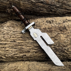 May include: A fixed-blade knife with a patterned steel blade featuring a cutout design and a small brass-colored inlay. The handle is wrapped in dark brown leather with black cord lacing and a metallic pommel. The blade has a textured finish.