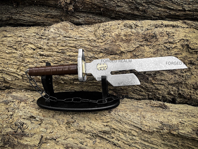 May include: A metal knife with a brown leather-wrapped handle, a brass-colored rectangular accent on the blade, and a cutout section near the hilt. The knife rests on a black oval stand with a decorative chain, featuring the text FORGED REALM.
