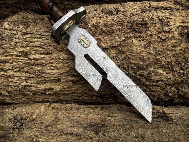May include: A metal sword with a textured, mottled silver blade featuring a distinct cutout section and a gold-colored rectangular inlay. The hilt has a brown leather-wrapped handle and a silver crossguard with gold accents near the blade base.