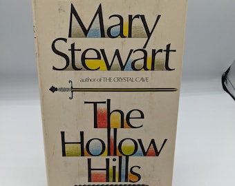 May include: A book titled "The Hollow Hills" by Mary Stewart, author of "The Crystal Cave". The title is in colorful, stylized lettering.