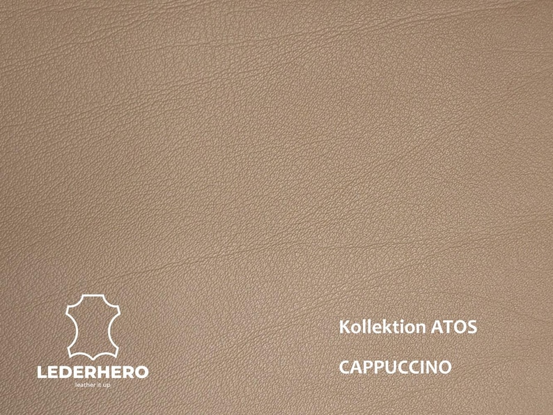 May include: Close-up of a textured, light brown leather material. The image includes the text "Kollektion ATOS" and "CAPPUCCINO". The logo for LEDERHERO is in the lower left corner.
