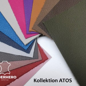 May include: A collection of leather swatches in various colors, including pink, purple, blue, and green. The swatches are arranged in a fan shape, showcasing the different textures and hues. The text "Kollektion ATOS" is visible.