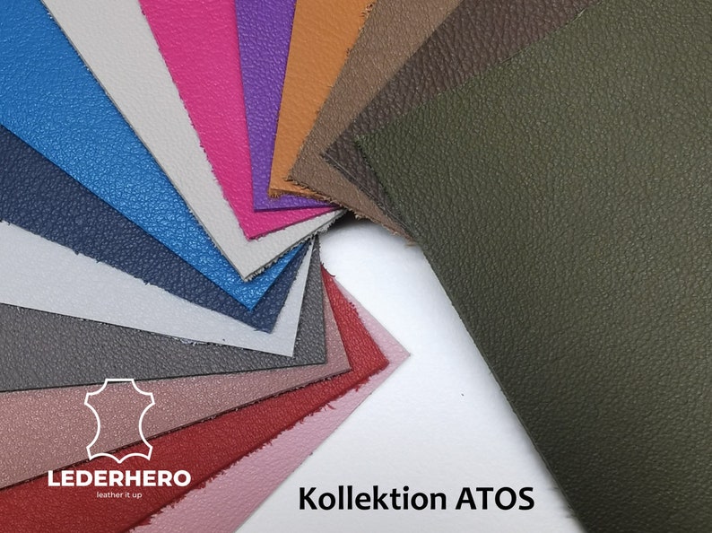 May include: A collection of leather swatches in various colors, including pink, purple, blue, and green. The swatches are arranged in a fan shape, showcasing the different textures and hues. The text "Kollektion ATOS" is visible.