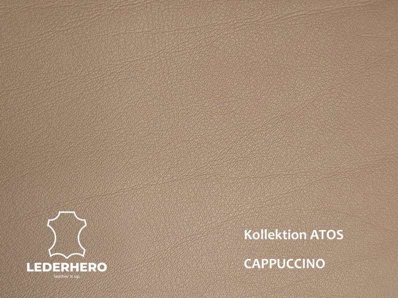 May include: A close-up of a light brown leather swatch with the text "Kollektion ATOS CAPPUCCINO" in white.