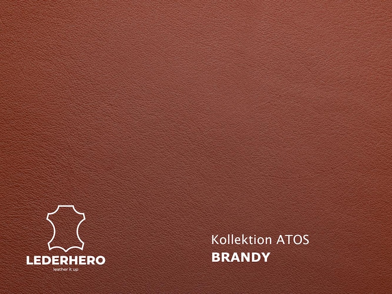 May include: Close-up of a textured, reddish-brown leather surface. The image includes the text "Kollektion ATOS BRANDY" and a logo for LEDERHERO, a leather goods company.