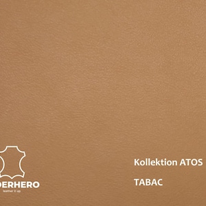 May include: Tan leather material with a subtle texture. The image includes the text "Kollektion ATOS" and "TABAC". The "LEDERHERO" logo is also visible in the lower left corner.