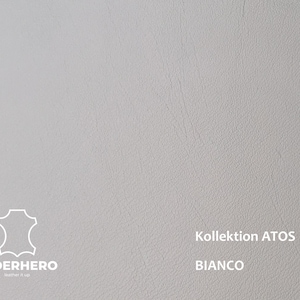 May include: A close-up of a white leather swatch with a textured surface. The text "Kollektion ATOS BIANCO" is printed in black at the bottom of the swatch.
