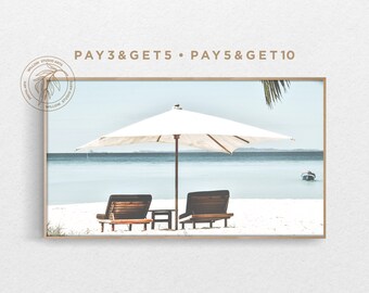 May include: A white beach umbrella with two wooden lounge chairs on a white sandy beach with a blue ocean in the background. The text "PAY 3 & GET 5 - PAY 5 & GET 10" is at the top of the image.
