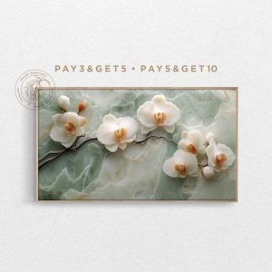 May include: A framed artwork featuring white orchid blossoms with orange centers on a dark branch. The orchids are set against a green and white marbled background. The text "PAY 3&GET 5 • PAY 5&GET 10" is at the top.
