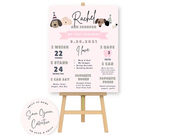 Könnte beinhalten: Ein rosa-weißes erstes Geburtstagsschild mit Hundemotiven. Das Schild zeigt "Rachel Ann Johnson" und "Mein erster Geburtstag" mit dem Datum "9.20.2021". Das Schild enthält auch Details zu Rachels Gewicht, Größe und Lieblingsdingen.