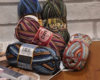 May include: Four balls of yarn in various colours and patterns. The yarn is labelled "NAKO Boho" and is made of 100% acrylic.