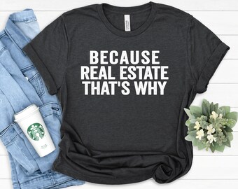 May include: A dark grey t-shirt with the text "Because Real Estate That's Why" printed in white.