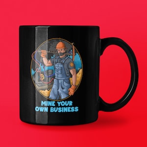 May include: Black coffee mug featuring a cartoon illustration of a person wearing a hard hat and a face mask, holding a pickaxe and standing in front of a computer screen with a Bitcoin symbol. The text "MINE YOUR OWN BUSINESS" is printed below the illustration.