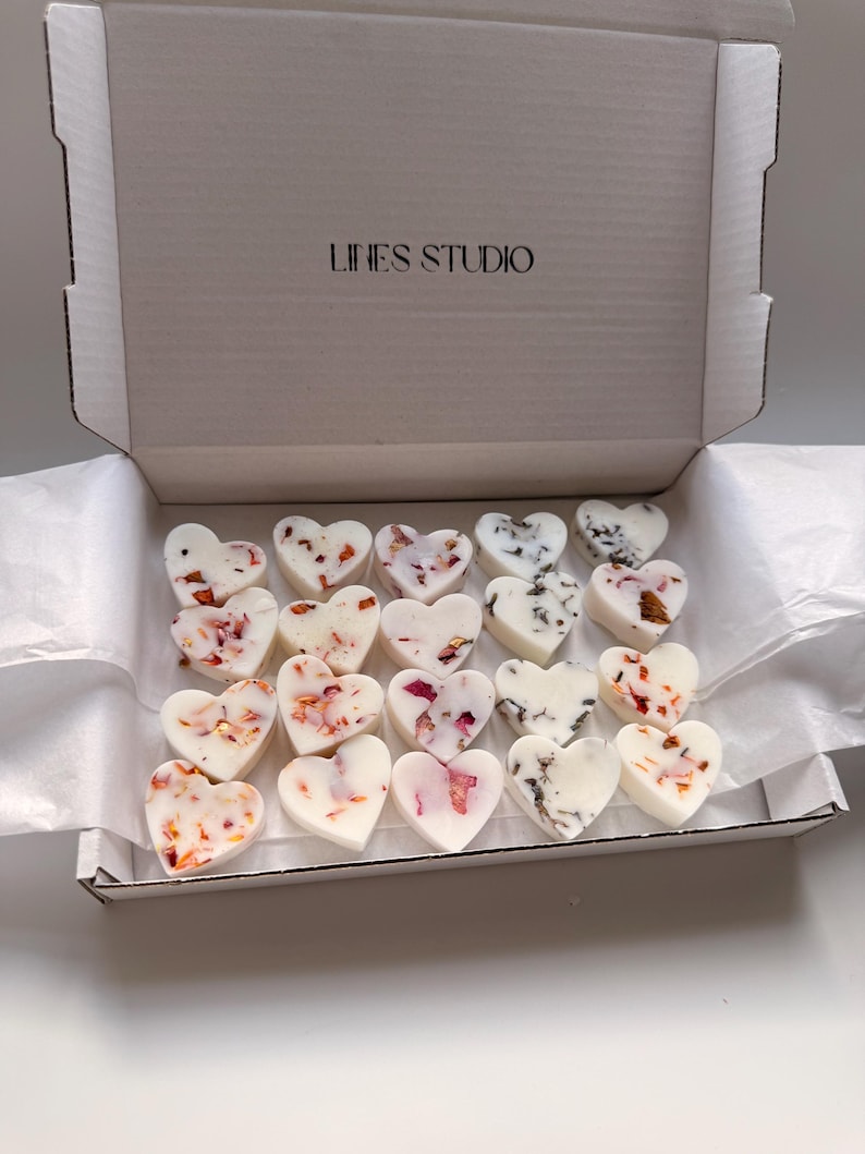 May include: A box of heart-shaped wax melts. The melts are white with floral and marbled accents. The box is white with the text "LINES STUDIO" on the lid.