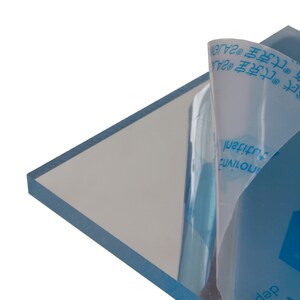 May include: A clear acrylic sheet with a protective film on one side. The film has blue text that reads "克宝2A", "主品克宝", "ZAJO", "SUARANTEE", "NO YELLOWING", "&Pi;&omicron;&tau;ί&nu;&eta;&sigmaf;", and "tutitanl".